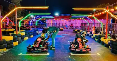 two people playing in bumper cars at an amusement park at Ipoh Meru 3 Bedroom Suites by IWH Suites in Ipoh