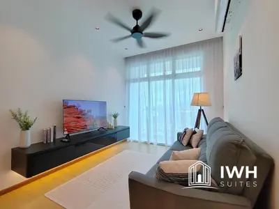 a living room with a couch and a flat screen tv at Ipoh Meru 3 Bedroom Suites by IWH Suites in Ipoh