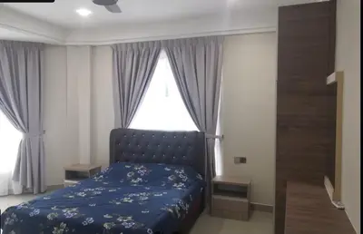 a bedroom with a blue bed in front of a window at Orkid Apartment Ringlet in Cameron Highlands