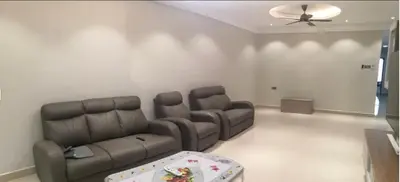 a living room with a couch and a ceiling fan at Orkid Apartment Ringlet in Cameron Highlands