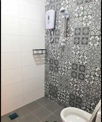 a bathroom with a shower with a toilet and a sink at Orkid Apartment Ringlet in Cameron Highlands