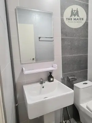 a bathroom with a white sink and a mirror at The Cove Hillside Residence Ipoh-Nature On Earth in Ipoh