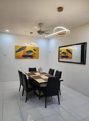 a dining room with a table and chairs at Dirgahayu Homestay I Rajawali in Kulim