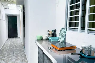 a kitchen with a counter top with a stove top at Bercham 81 Homestay in Ipoh