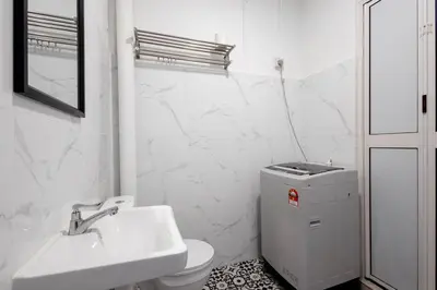 a white bathroom with a sink and a toilet at Casa for 4 - Private Studio Ipoh in Ipoh