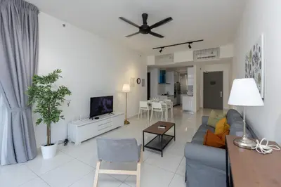 a living room with a blue couch and a tv at Beacon Executive Suite by MAY in George Town
