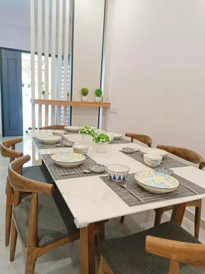 a dining room table with plates and bowls on it at Penang Georgetown Jelutong Luxury House 1-12Pax in Jelutong