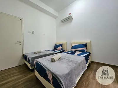 a room with two beds and a door in it at The Cove Ipoh - Blissful Abodes in Tambun