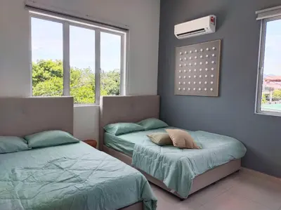 two beds in a room with two windows at Tints of Green Pool Bungalow-6 Bedroom-Karaoke-BBQ in Sultan Azlan Shah Airport
