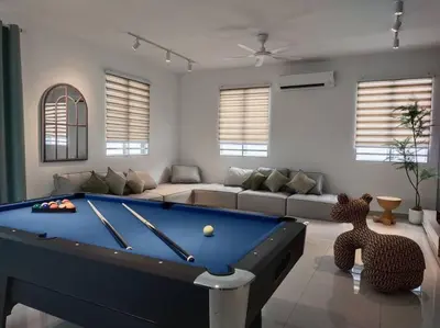 a living room with a pool table and a couch at Tints of Green Pool Bungalow-6 Bedroom-Karaoke-BBQ in Sultan Azlan Shah Airport