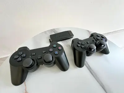 three video game controllers sitting on top of a table at Stylish Cozy Landed Jelutong 3BR 2B 4CP-10pax by 3C in Jelutong
