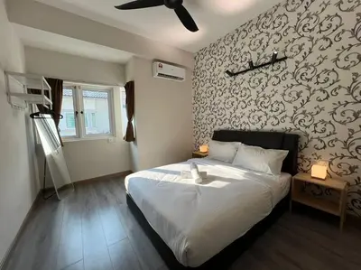 a bedroom with a large white bed with a wall at Karpal Singh Drive Seaside Georgetown 4BR-15pax by 3C in George Town