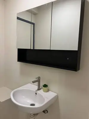 a bathroom with a white sink and a mirror at Karpal Singh Drive Seaside Georgetown 4BR-15pax by 3C in George Town