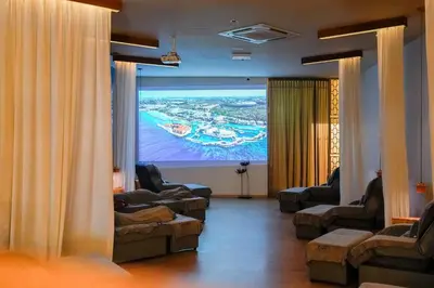 a room with couches and a large screen at Robin Hotel in Ipoh