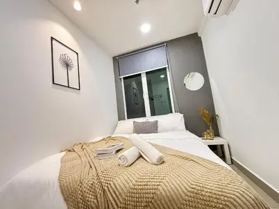 a bedroom with a bed with two towels on it at Ipoh Town Majestic Suites by IWH Suites in Ipoh