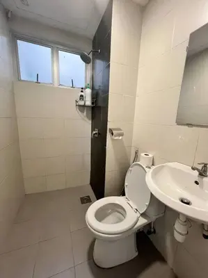 a white bathroom with a toilet and a sink at LIly Brava 7 in Tanah Rata