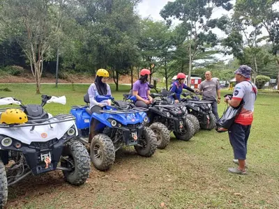 a group of people sitting on atvs in a field at Lemuni Retreat & Training Centre - Kerling, Selangor in Kerling