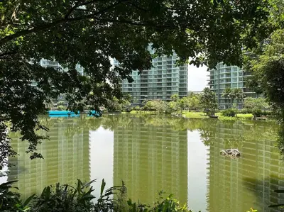 a body of water in front of a large building at Ipoh lakeside Suite Ipoh 4pax in Ipoh