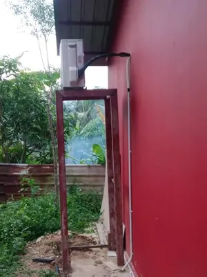 a mirror leaning against a red wall next to a building at Renovate on progress in Kuala Kubu Baharu