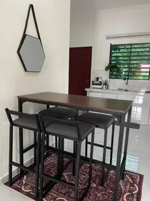 a wooden table with four chairs and a kitchen at Rumah Kita HStay BM view Self check in 2Room in Kubang Semang