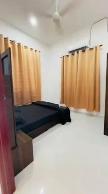 a room with a bed and a tv and curtains at Rumah Kita HStay BM view Self check in 2Room in Kubang Semang