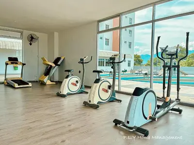 a gym with several treadmills and elliptical machines at Kampung Paloh Residence Ipoh with 2 Parking & Free Netflix in Ipoh