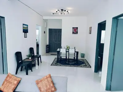 a living room with a table and chairs at Ammara Homestay Emerald Avenue Cameron Highlands in Brinchang