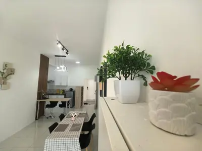 a kitchen with a table and a potted plant on a counter at Ipoh Anderson Suite 1802 By Hopestay in Ipoh