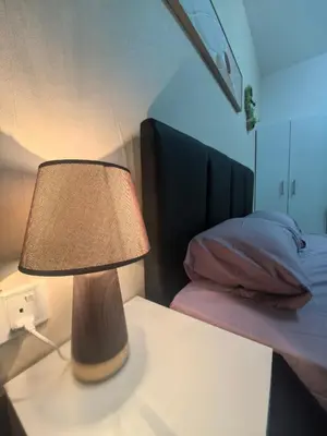 a lamp on a table next to a bed at Ipoh Anderson Suite 1802 By Hopestay in Ipoh