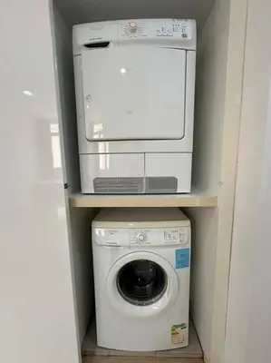 a washing machine with a microwave on top of it at Netflix Studio Seaview 118Island Plaza in Tanjong Tokong