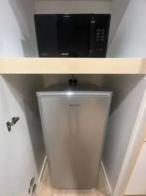 a microwave sitting on top of a shelf at Netflix Studio Seaview 118Island Plaza in Tanjong Tokong