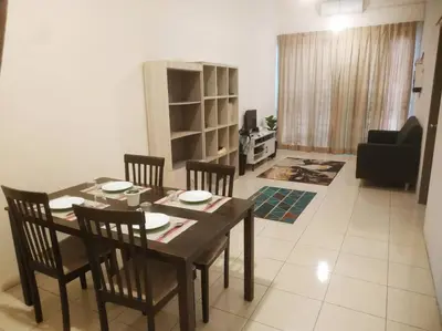 a dining room table and chairs in a living room at Setia Homestay Chemor Setia in Chemor