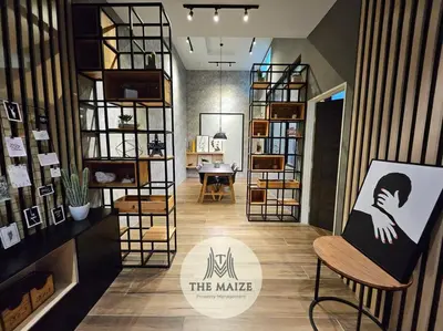 a room with a painting on a chair and shelves at The Urban Lodge - Tasek Avenue Ipoh in Ipoh