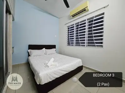 a bedroom with a bed with a cross on it at Cozy Nest - Sky Garden Residence Ipoh in Chemor