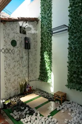 a room with a shower with ivy on the wall at The Bibik at 8 Clarke -NEW Entire #Unesco #HeritageHome in George Town