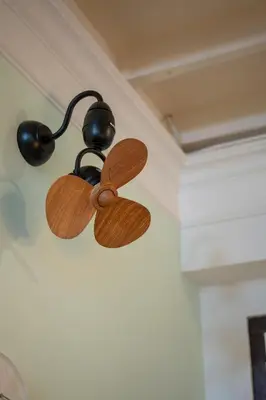 a wooden ceiling fan hanging from a wall at The Bibik at 8 Clarke -NEW Entire #Unesco #HeritageHome in George Town