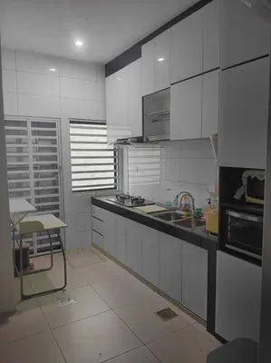 a kitchen with white cabinets and a sink at Mysa at Tambun Ipoh in Kampong Batu Lapan