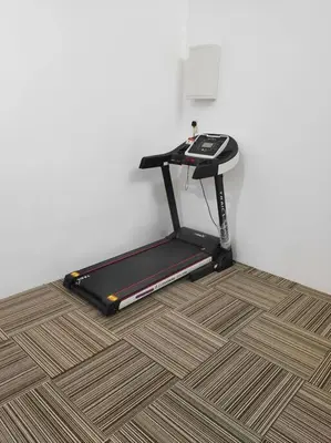 a treadmill is sitting on the floor next to a wall at Mysa at Tambun Ipoh in Kampong Batu Lapan