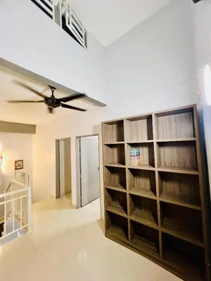 a room with book shelves and a ceiling fan at Khalifah Homestay Penaga in Penaga