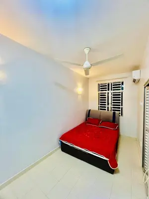 a red bed in a white room with a ceiling at Khalifah Homestay Penaga in Penaga