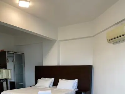 a bedroom with a bed with white sheets and white pillows at Marina Heights Apartment in Lumut