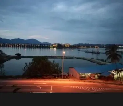a view of a large body of water at night at Marina Heights Apartment in Lumut