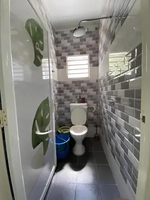 a bathroom with a white toilet in a room at Rumah Bukit Jalan Kolam Air in Kuala Kubu Baharu