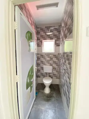 a bathroom with a toilet in a room at Rumah Bukit Jalan Kolam Air in Kuala Kubu Baharu