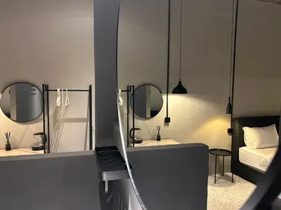 a room with two mirrors and a bed in it at M2 Living Townhouse in Ipoh in Ipoh