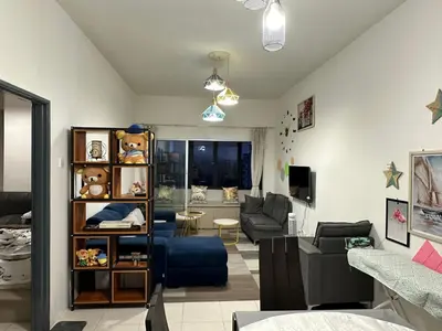 a living room with a blue couch and a living room at AYAAN HOMESTAY HiLL ViEW IIN FREE WIFI & NETFLIX in Tanah Rata