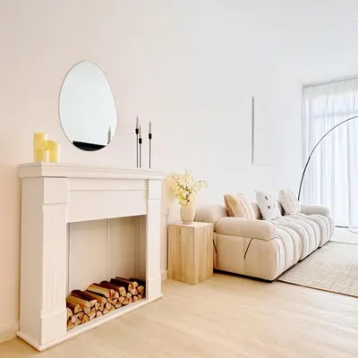 a living room with a couch and a mirror over a fireplace at Beacon Georgetown Skypool Cityview Free 2 Carpark in George Town