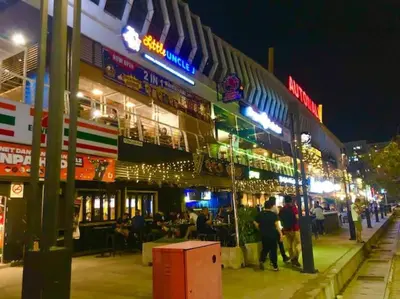 a group of people standing outside of a building at night at Seaview Seafront Duplex in Town with WiFi & Full Kitchen 83A in Georgetown