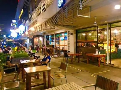 a group of people sitting at tables in a restaurant at Seaview Seafront Duplex in Town with WiFi & Full Kitchen 83A in Georgetown