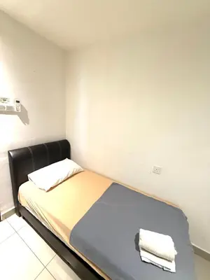 a bedroom with a bed with two towels on it at The Majestic Ipoh 3BR - Goswell in Ipoh